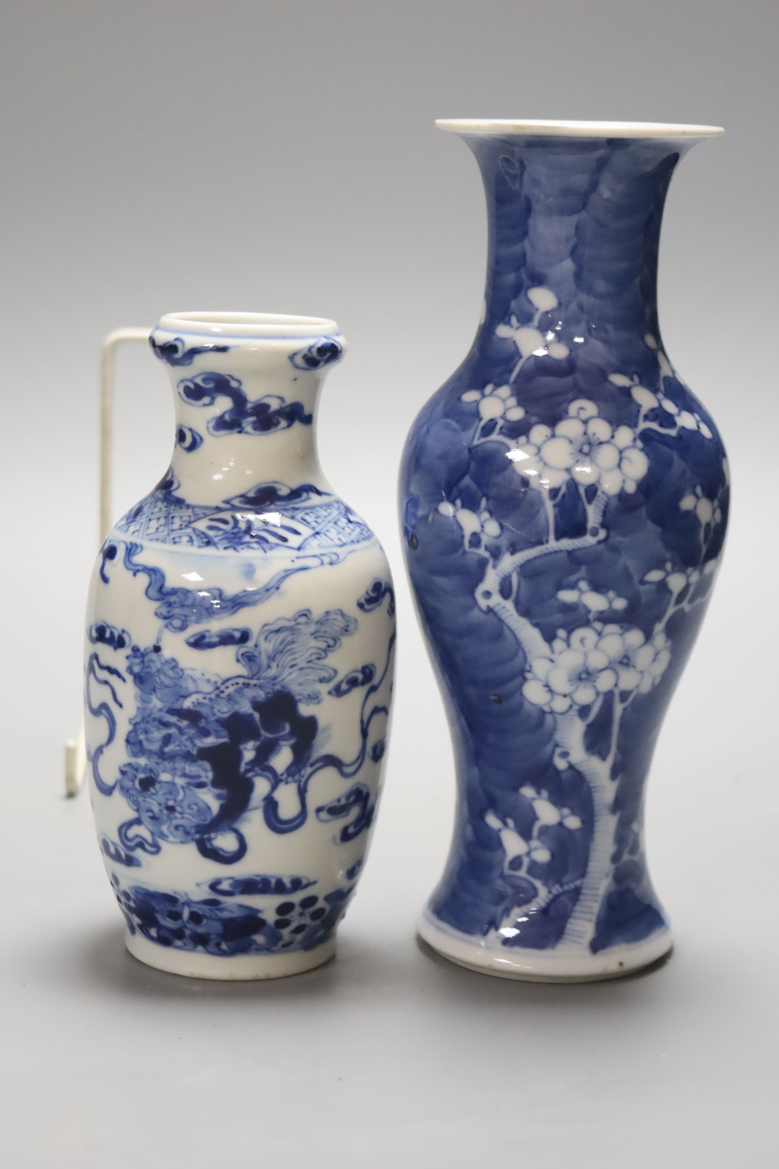 Two Chinese blue and white vases and a dish, together with a famille rose dish, tallest 28cm